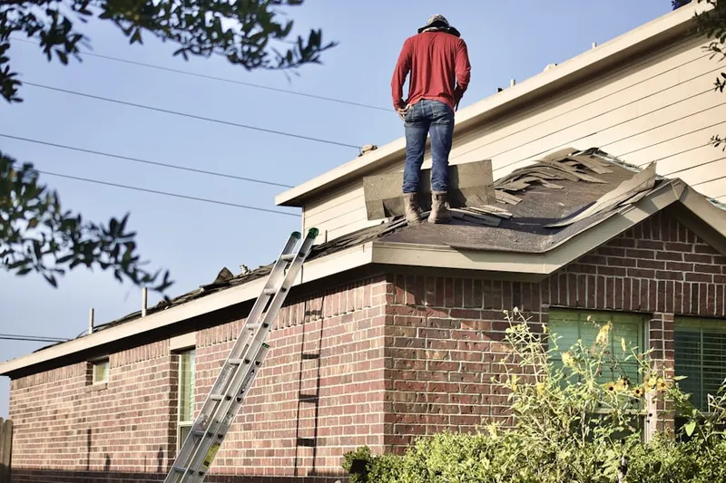 Professional roofer working on a residential roof in Newport Heights
